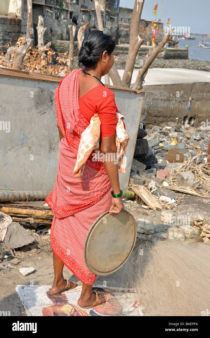 A Kobi Woman waiting for the days catch from the Fishing Boats, Colaba, South Mumbai, India Stock Photo
