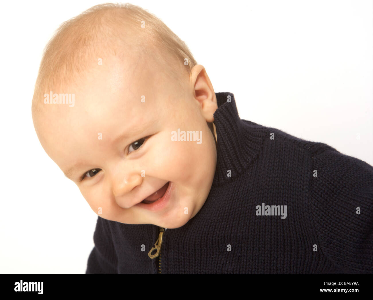A baby laughs against a white background (angled) Stock Photo