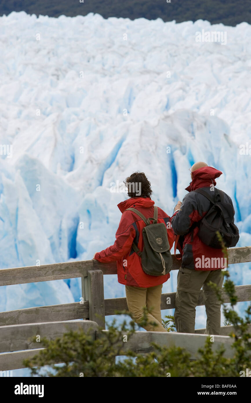 Couple at overlook Perito Moreno Glacier - Los Glaciares National Park, Argentina Stock Photo