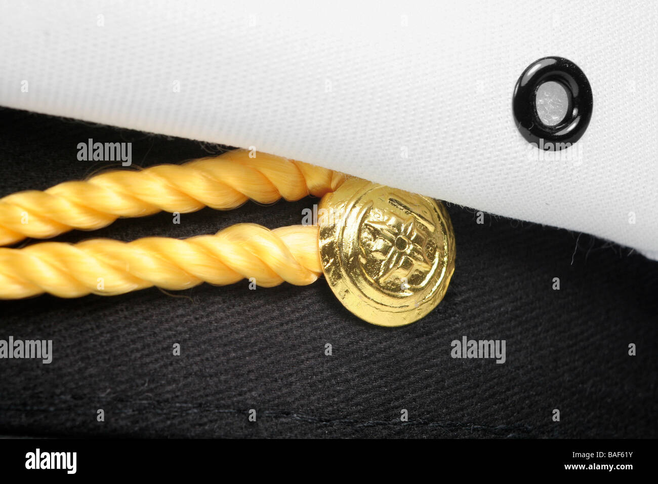 Brass button and braid on sea captain's hat Stock Photo