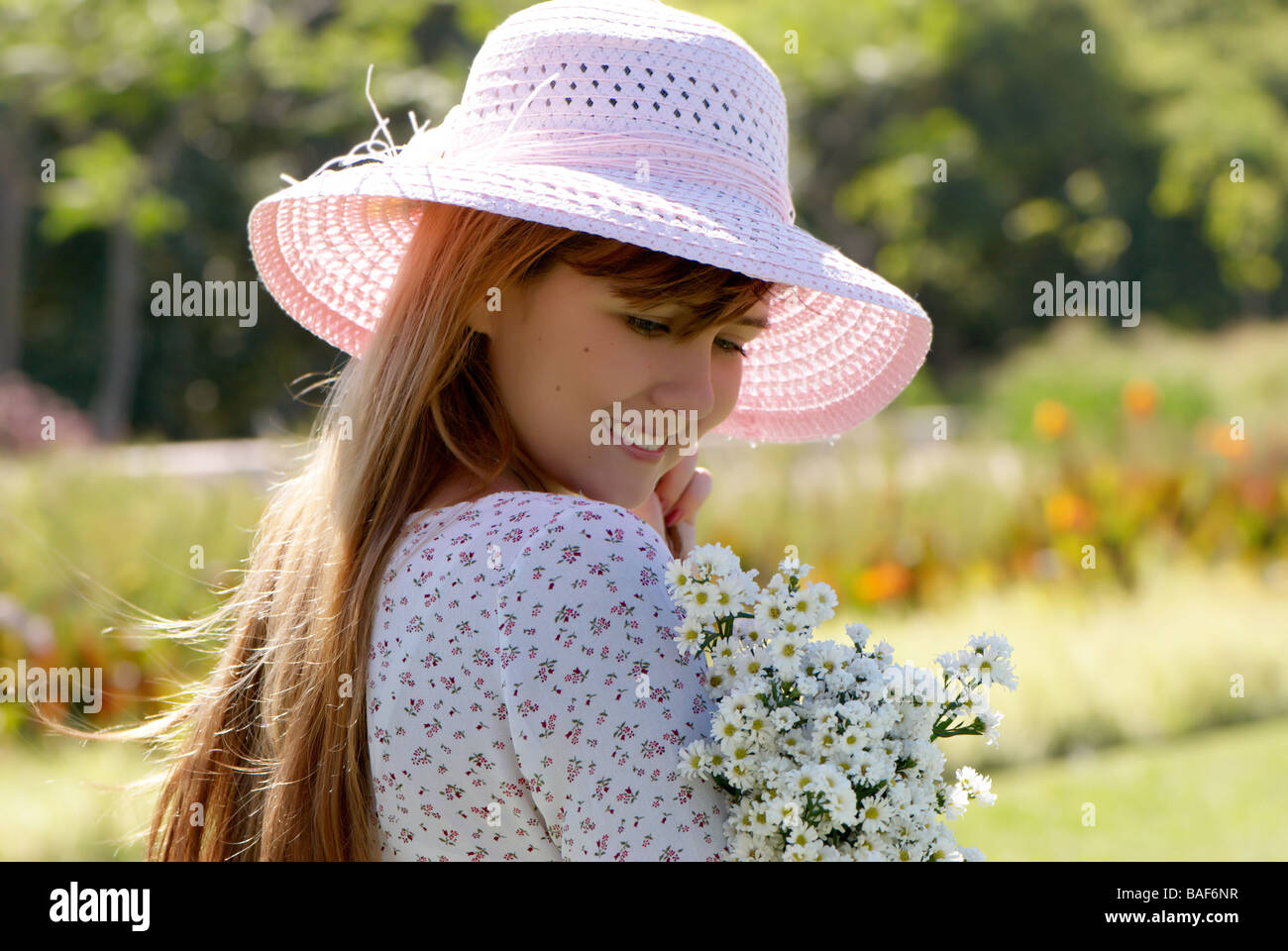 The girl in a hat with a bunch of flowers Stock Photo - Alamy