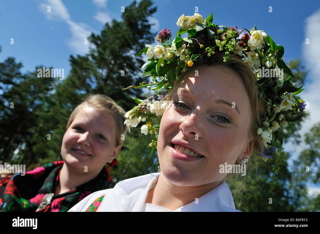 Smiling women with floral wreath at Midsummer celebration in Doessberget Sweden June 2008 Stock Photo