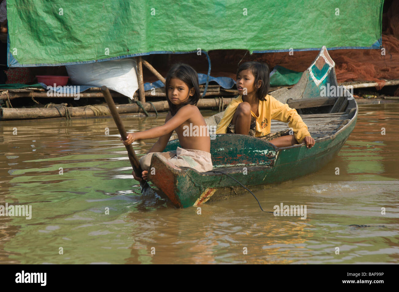 Cambodian Girls In A Small Boat Floating Village On The Tonle Sap Lake cambodian-girls-in-a-small-boat-floating-village-on-the-tonle-sap-lake