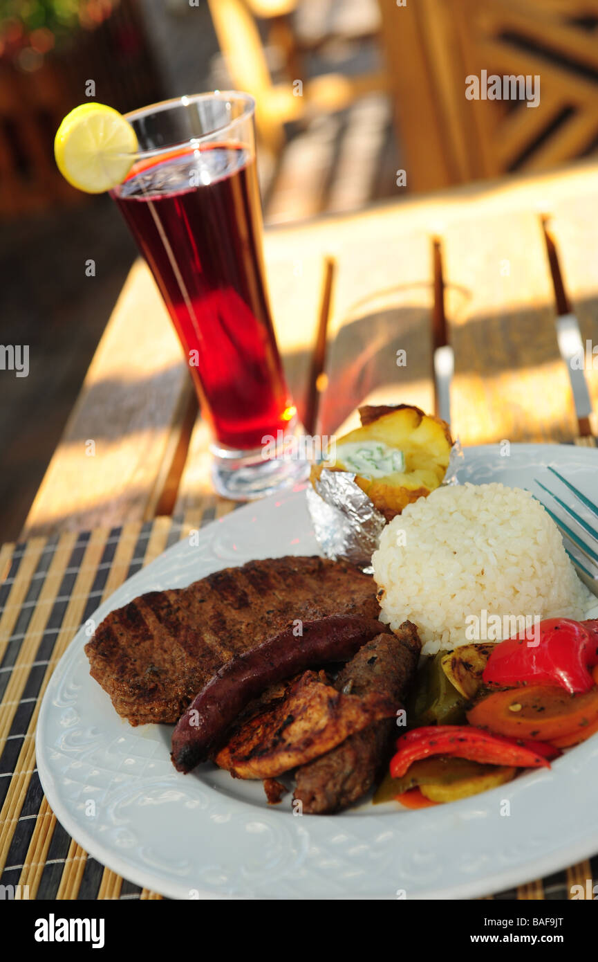 Africa Egypt Food a meal of grilled meats rice and potato along with a glass of hibiscus tea Stock Photo