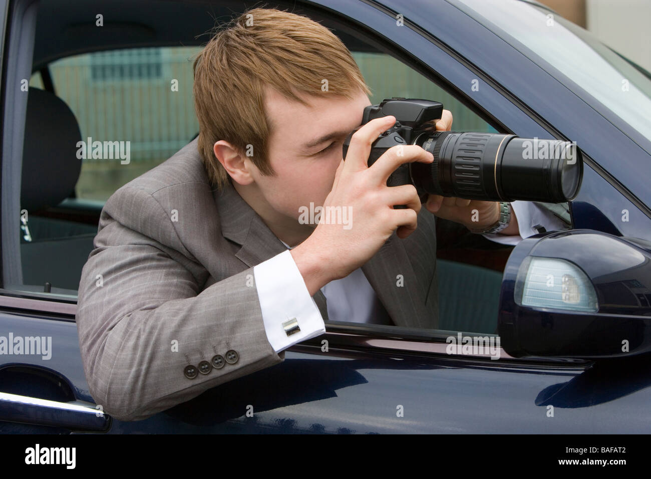 Man doing surveillance with a camera from his car Stock Photo Alamy