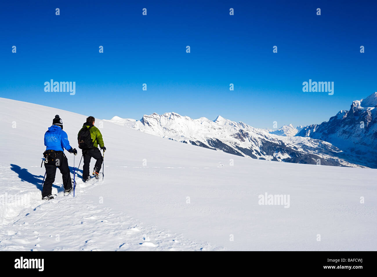 Two persons snowshoeing Maennlichen Grindelwald Bernese Oberland Canton