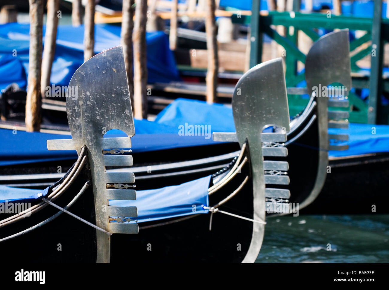 Line of three metallic gondola ferros. Small depth-of-field. Venice Italy Stock Photo