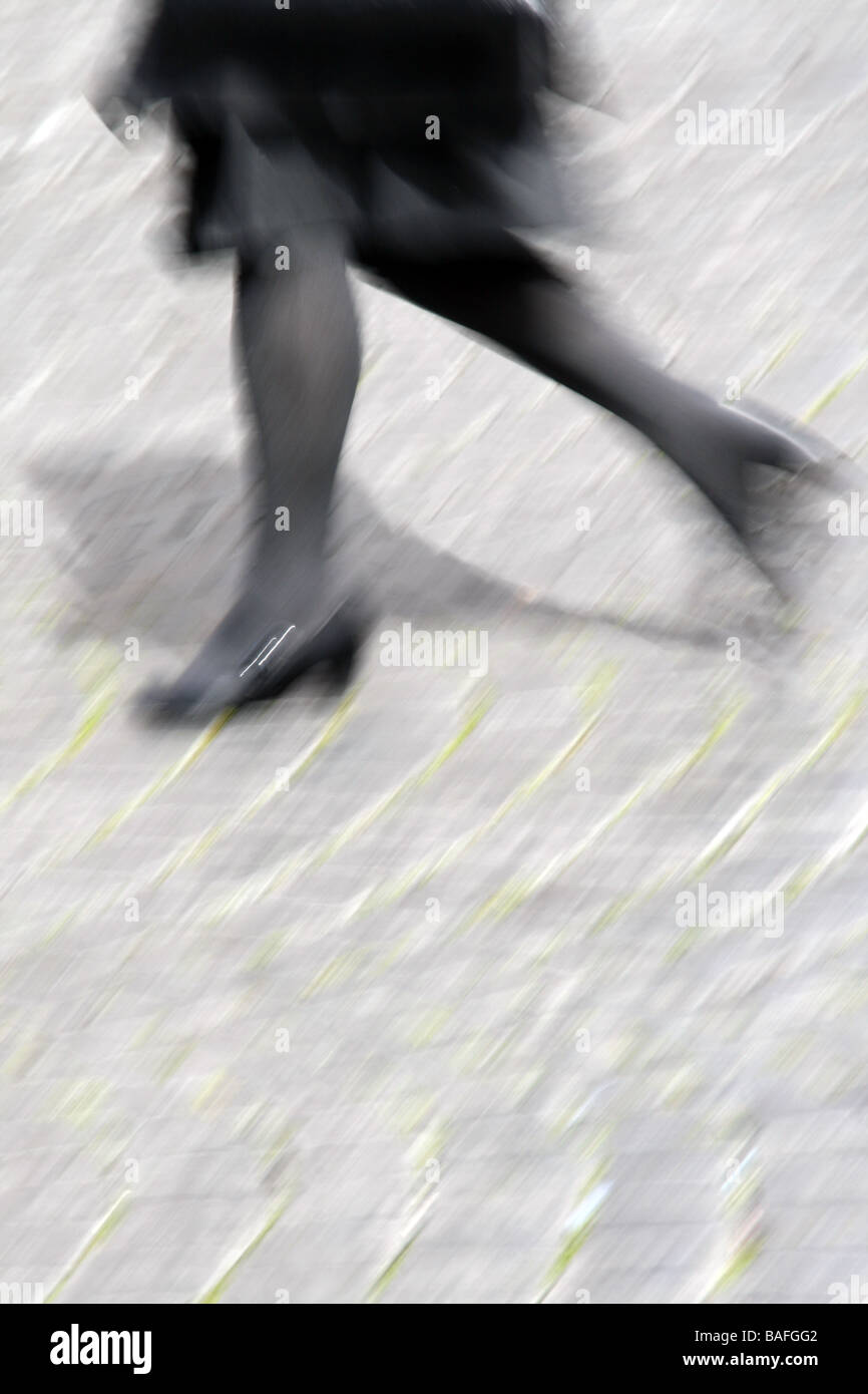 one woman walking crossing road in city town Stock Photo - Alamy