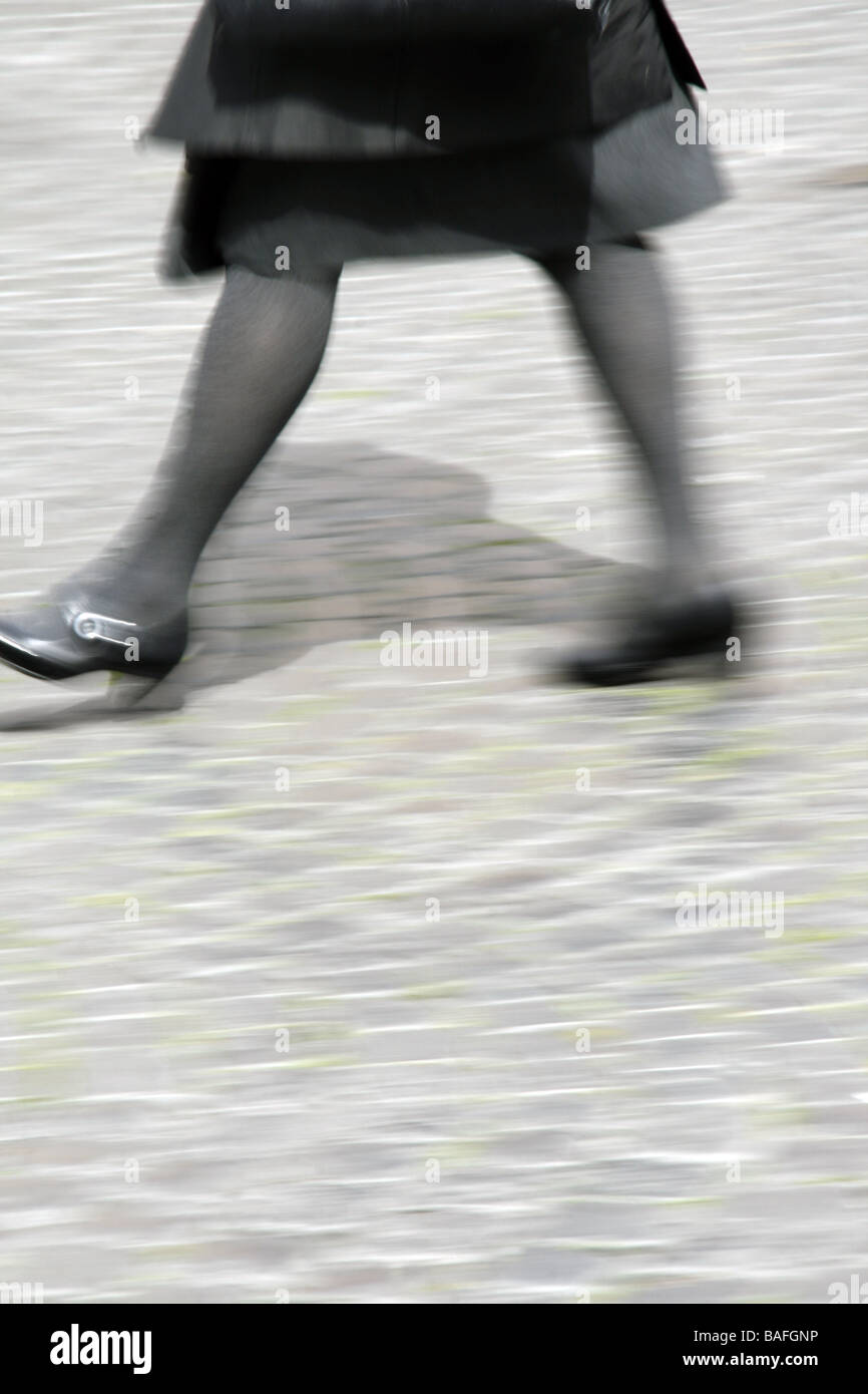 one woman walking crossing road in city town Stock Photo - Alamy