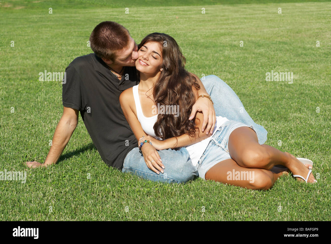 Happy young pair kissing outdoors Stock Photo - Alamy