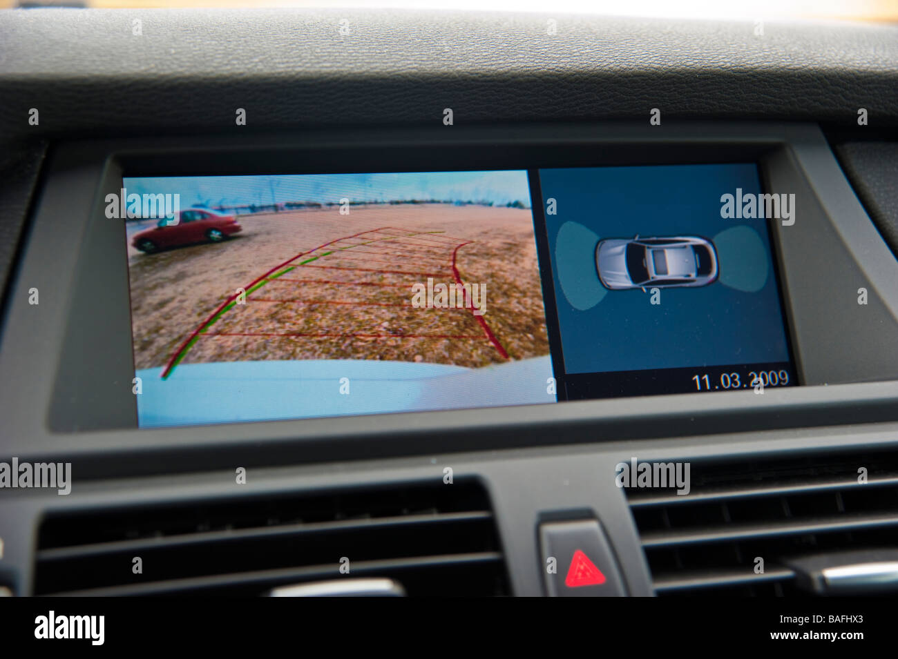 Display in BMW X6 showing rear view camera with steering guides Stock