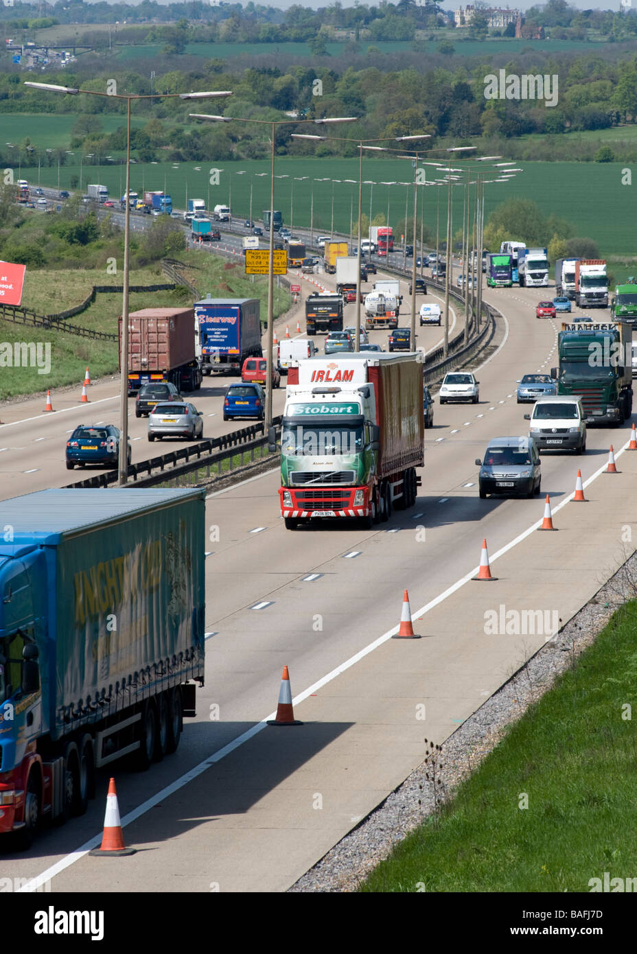 Heavy goods traffic passes through Essex on the M25 London Orbital Motorway towards the Queen Elizabeth II Bridge. Stock Photo