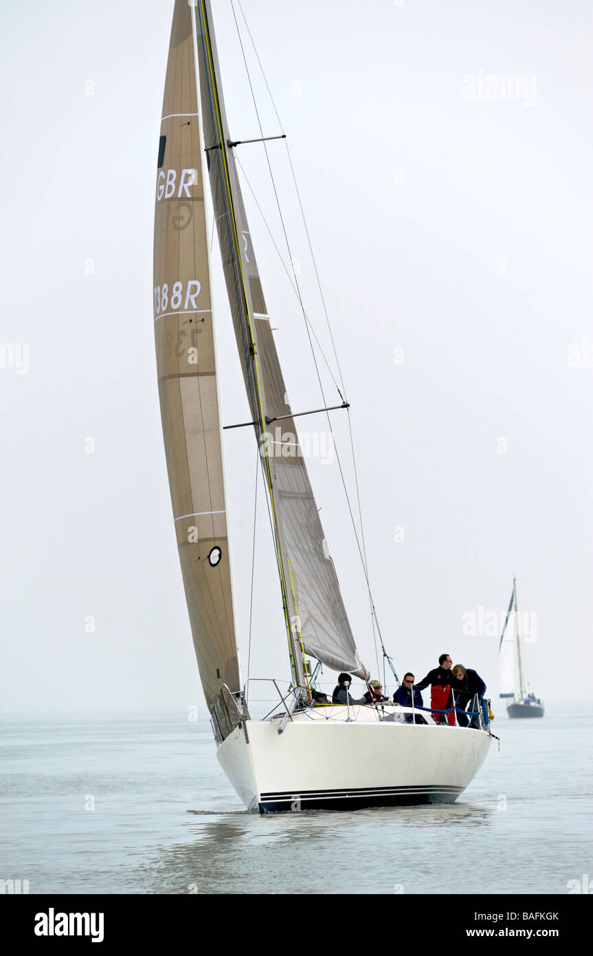 Sailing in misty conditions racing yachts off eastbourne East Sussex England in light wind conditions Stock Photo