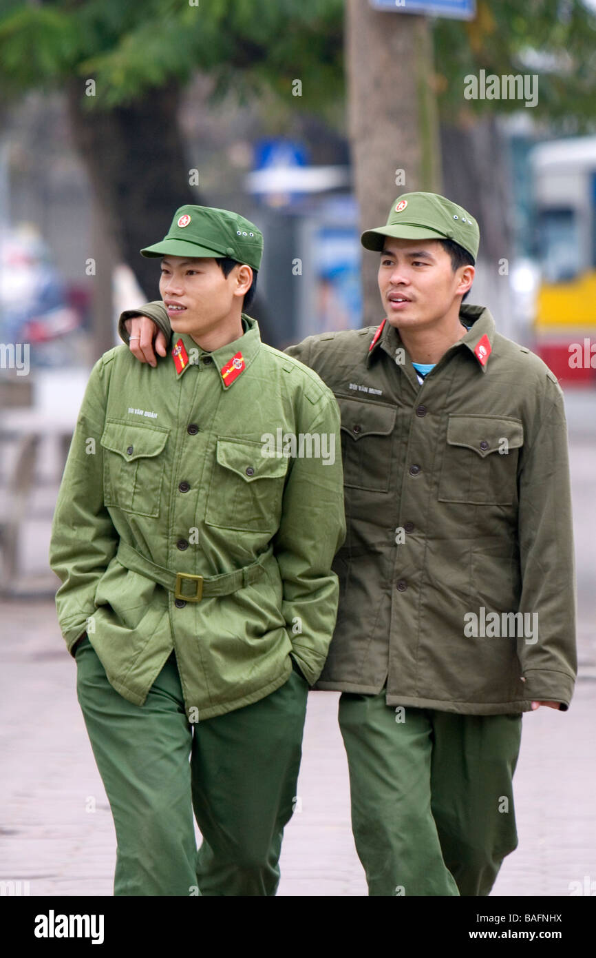 Vietnamese soldiers walk close together as a cultural gesture in Hanoi Vietnam Stock Photo