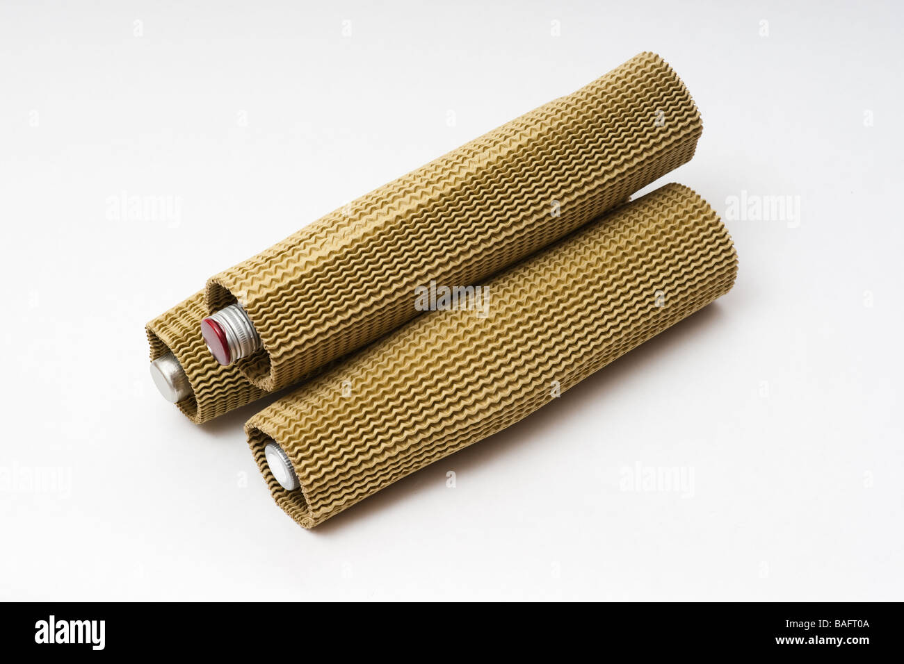 Three stacked bottles wrapped in corrugated cardboard transport protectors and ready for shipping Stock Photo