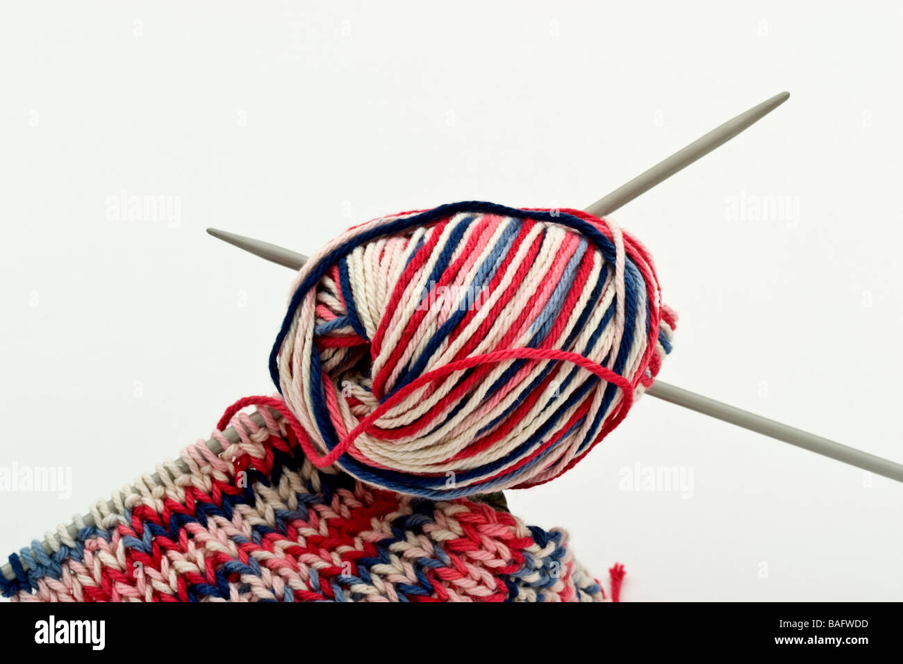 Two knitting needles in a ball of multicoloured yarn Stock Photo Alamy