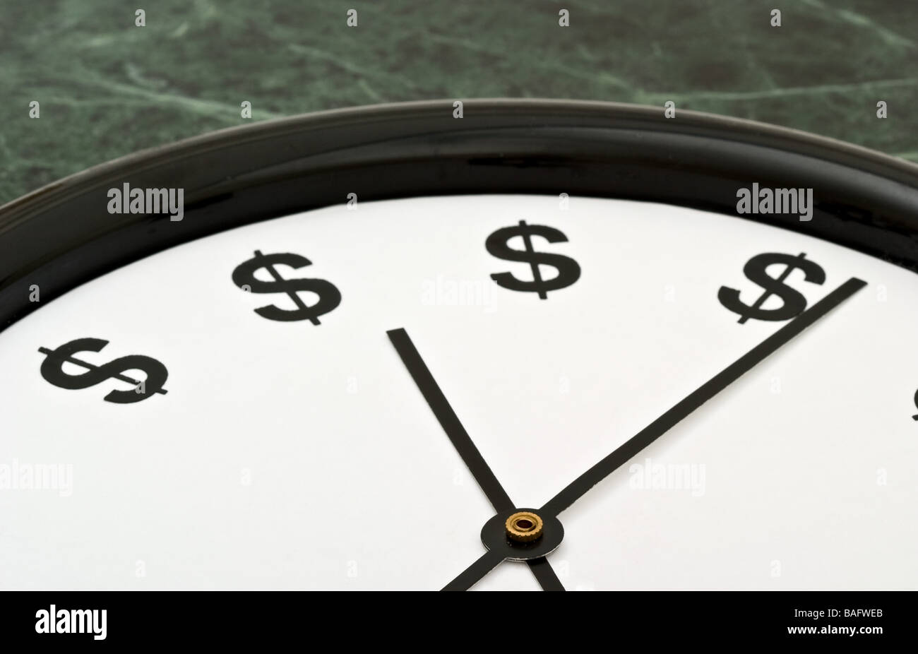 White clock with the hands pointing towards dollar signs Stock Photo
