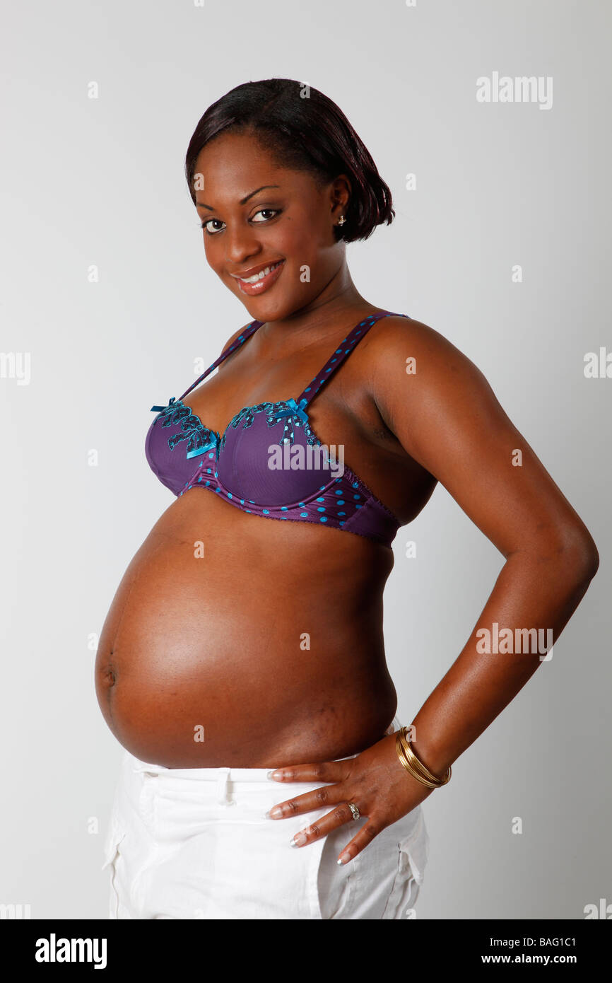 pretty black girl heavily pregnant  showing off  her belly Stock Photo