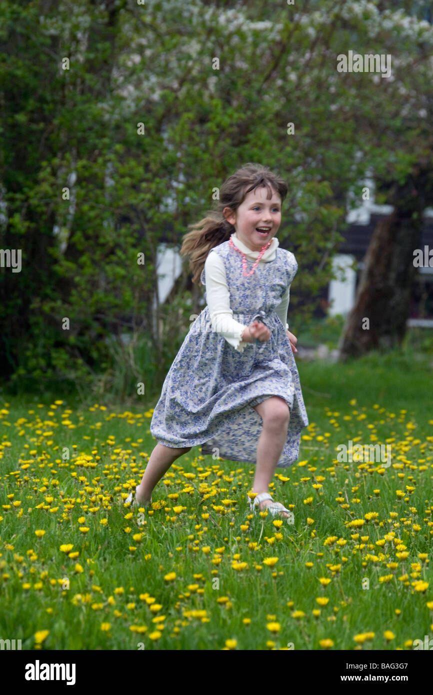 Young girl running through flowers Pemperton British Columbia Canada Stock Photo