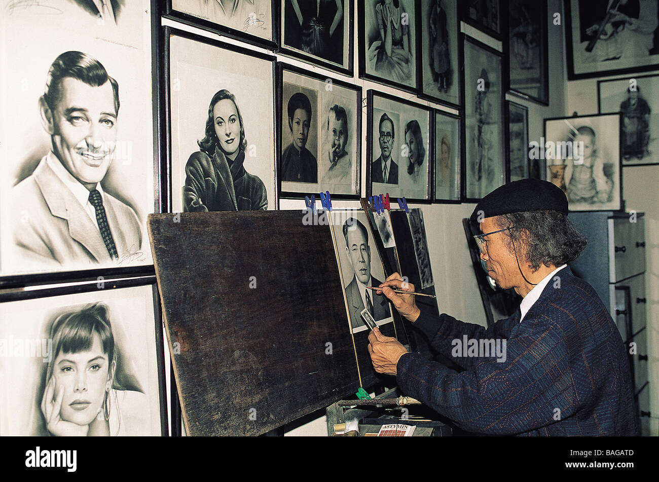Vietnam, Hanoi, artist drawing pictures adapted from photographs, here Clark Gable and Mathilda May Stock Photo