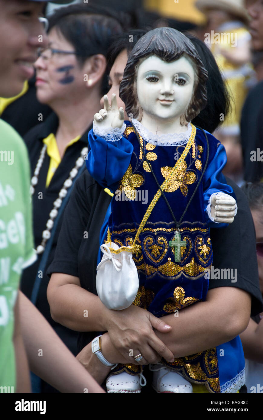 Santo Niño figure being carried by participant in Ati-Atihan festival in Kalibo, Panay, Philippines Stock Photo
