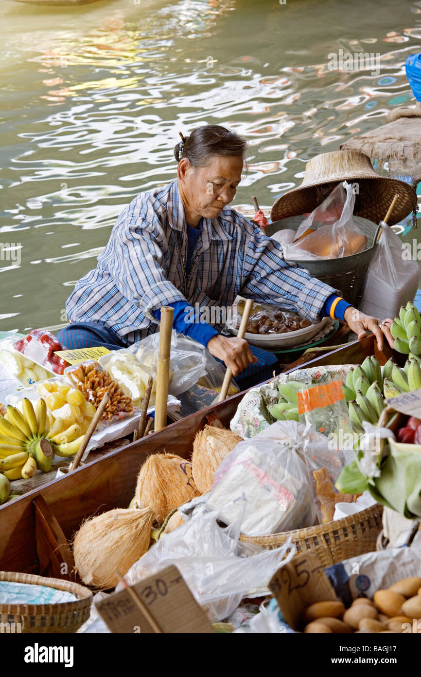 Selling food and souvenirs at the Damnoen Saduak floating market located about 62 miles outside of Bangkok Thailand Stock Photo