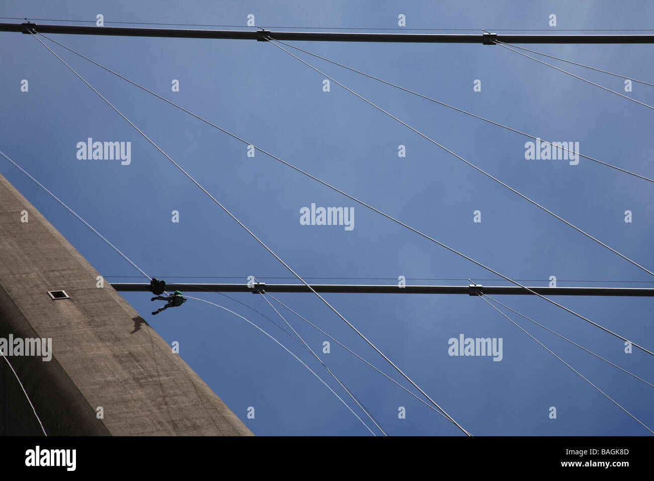 Two people rappel off the Humber Bridge in Hull, England Stock Photo