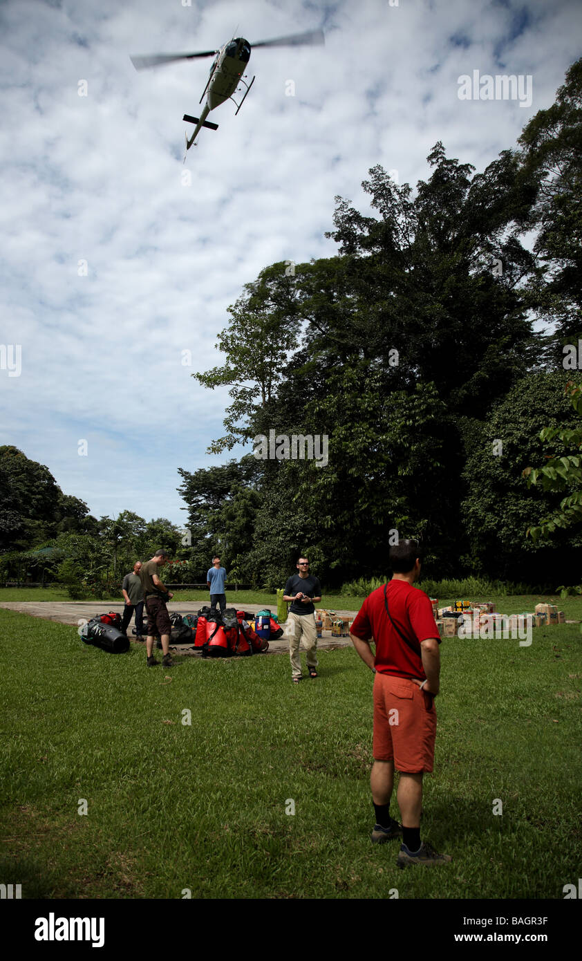 Awaiting the arrival of a helicopter to land and carry supplies up into the jungle prior to the start of a caving expedition Stock Photo