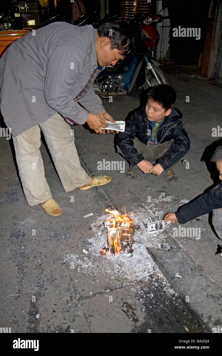 Vietnamese people burn photocopied U S dollars for good luck and prosperity during Tet festivities in Hanoi Vietnam Stock Photo