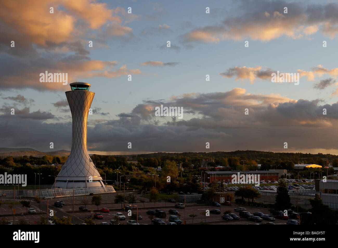 air traffic control tower landscape view from car park with pink clouds ...