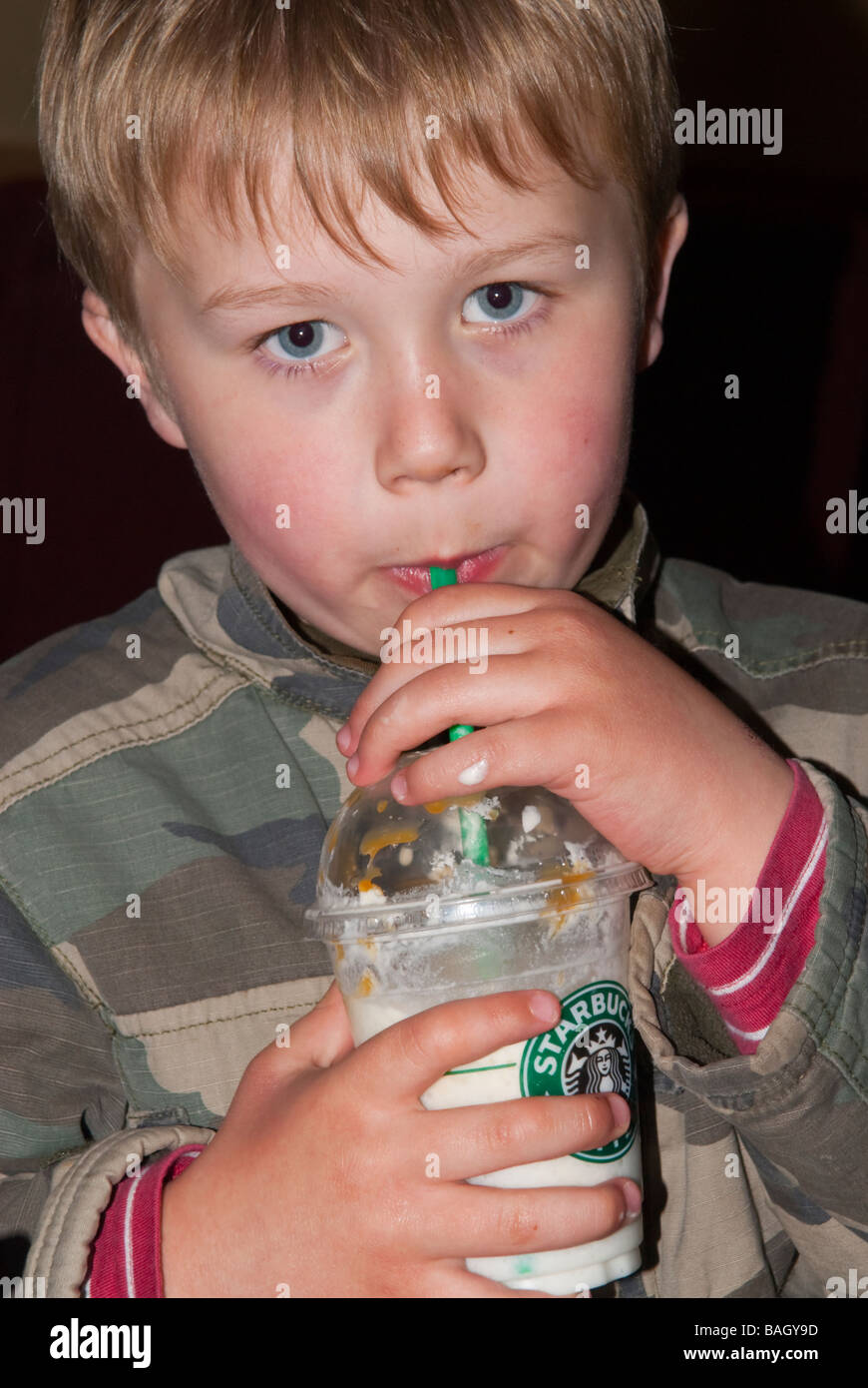 A young white boy drinking a frappucino drink from starbucks coffee shop in  the uk Stock Photo - Alamy