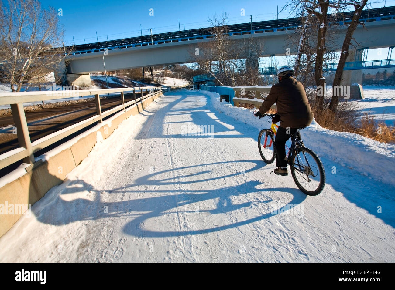 Edmonton, Alberta, Canada; Person riding a bike in the winter Stock