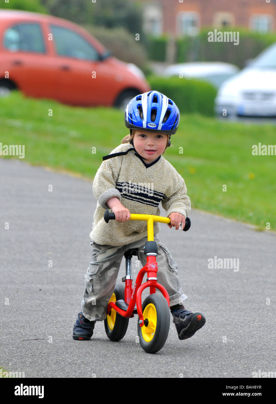 Boy learning to ride a balance bike Stock Photo Alamy