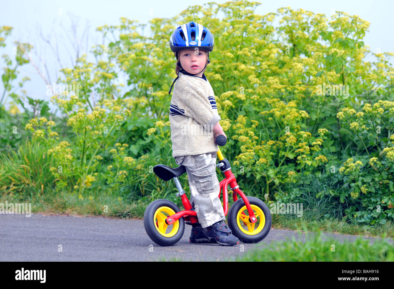 Boy learning to ride a balance bike Stock Photo Alamy