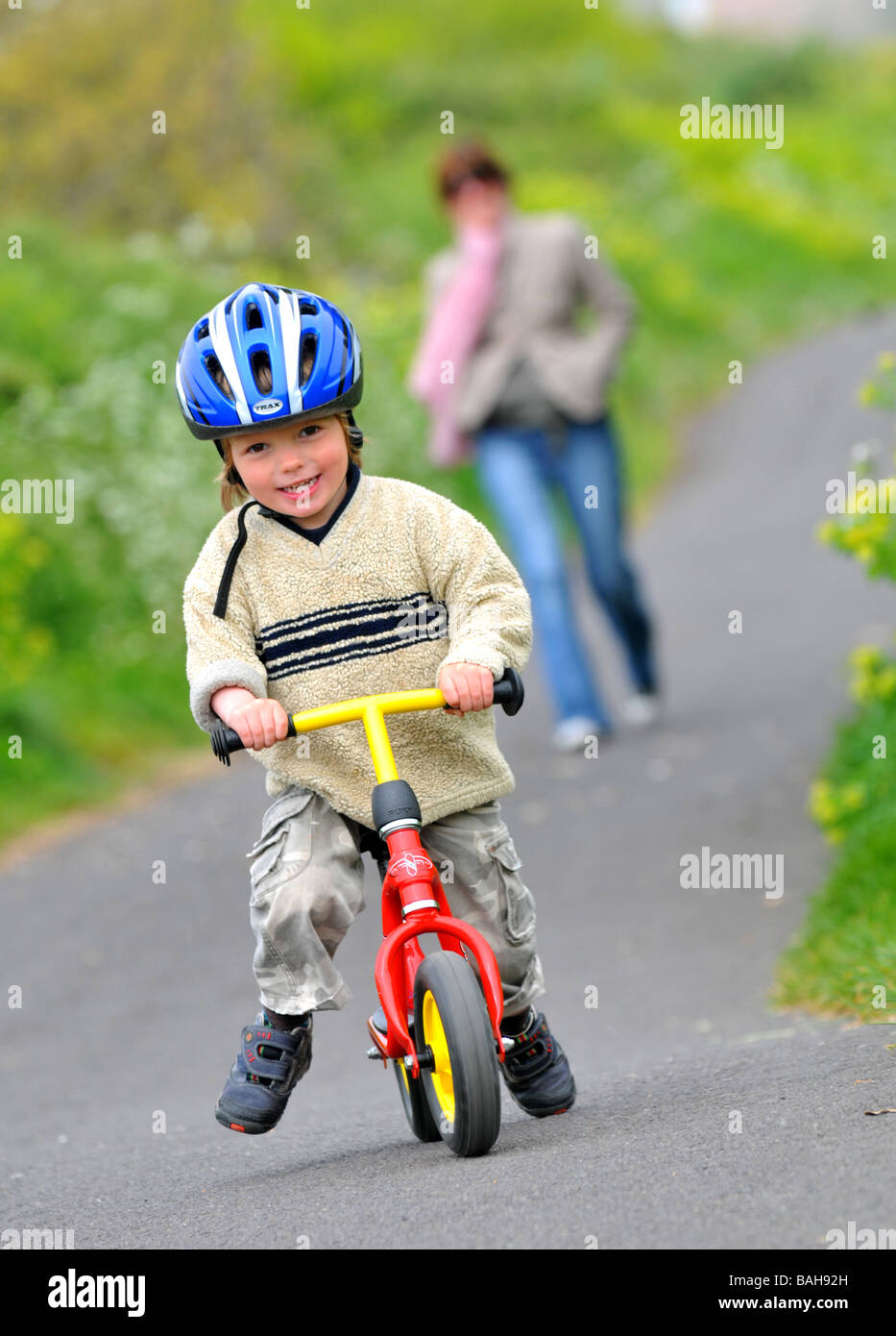 Boy learning to ride a balance bike Stock Photo