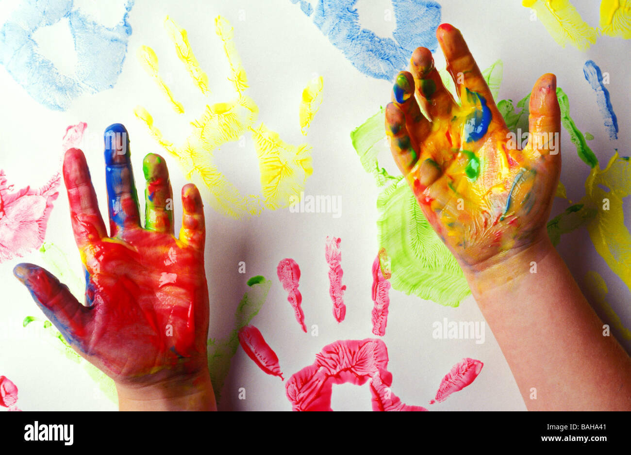 Child s hands covered in paint Stock Photo Alamy