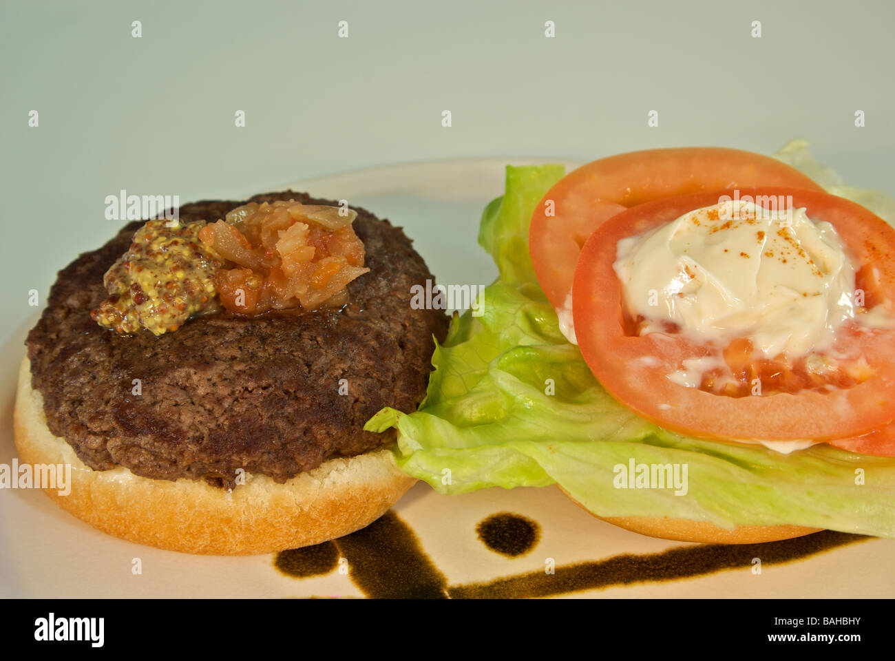 Deluxe hamburger lettuce tomato relish mustard mayonnaise on a bun Stock Photo