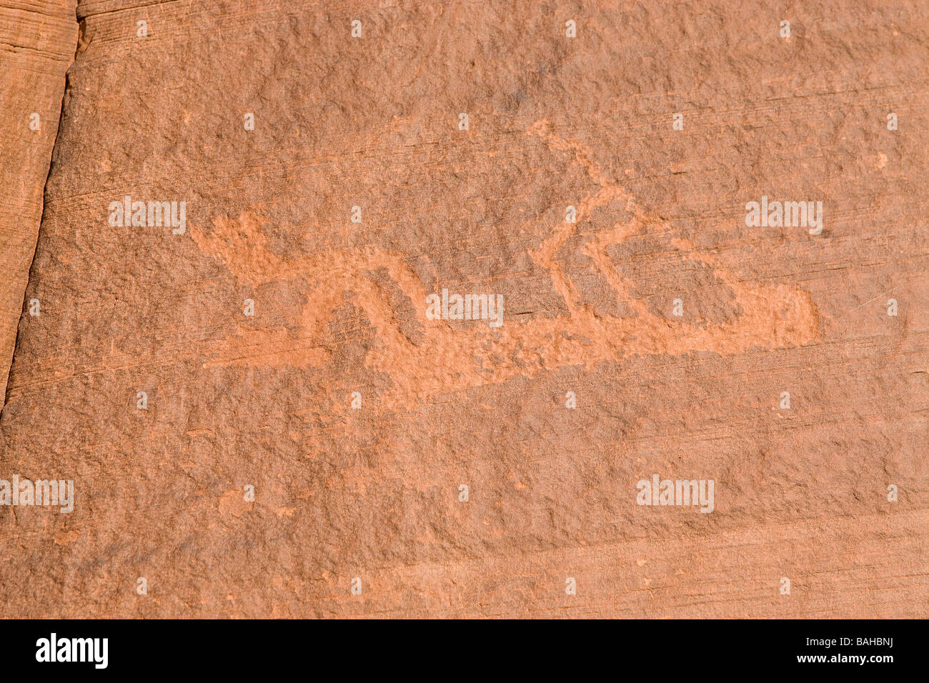 Navajo hieroglyphics carved in sandstone showing kokopelli Stock Photo