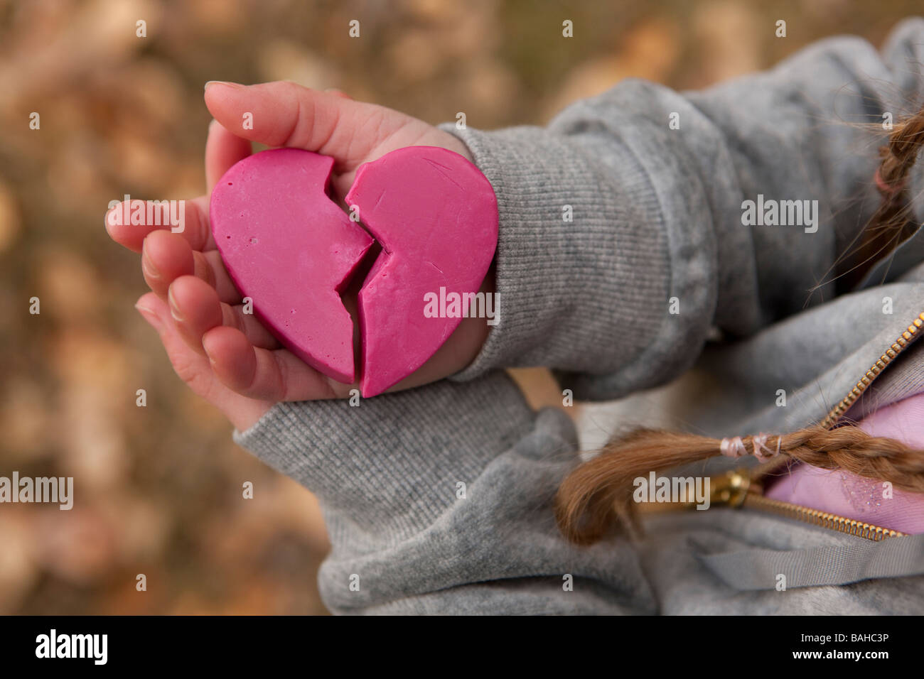Girl holding broken heart Stock Photo - Alamy