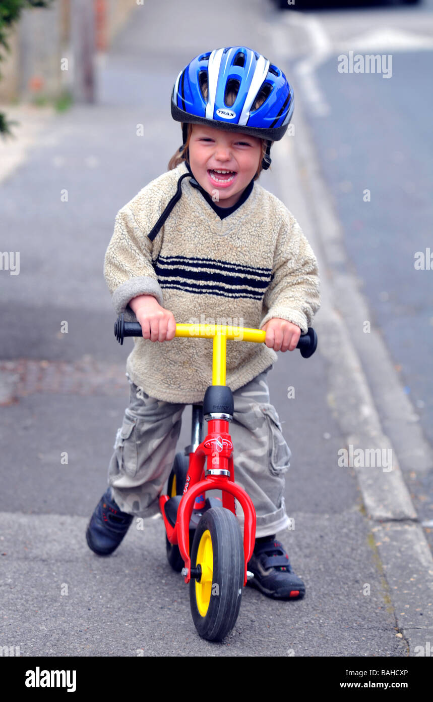 Boy learning to ride a balance bike Stock Photo