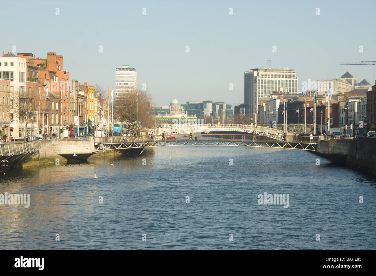 Waterfront buildings and footbridge crossing River Liffey, Dublin, Ireland Stock Photo