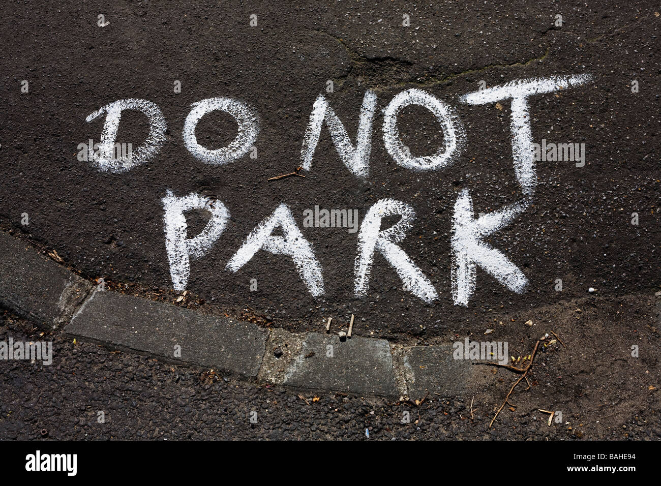 The words Do Not Park have been painted roughly on a kerbside street corner in the London borough of Lambeth England Stock Photo