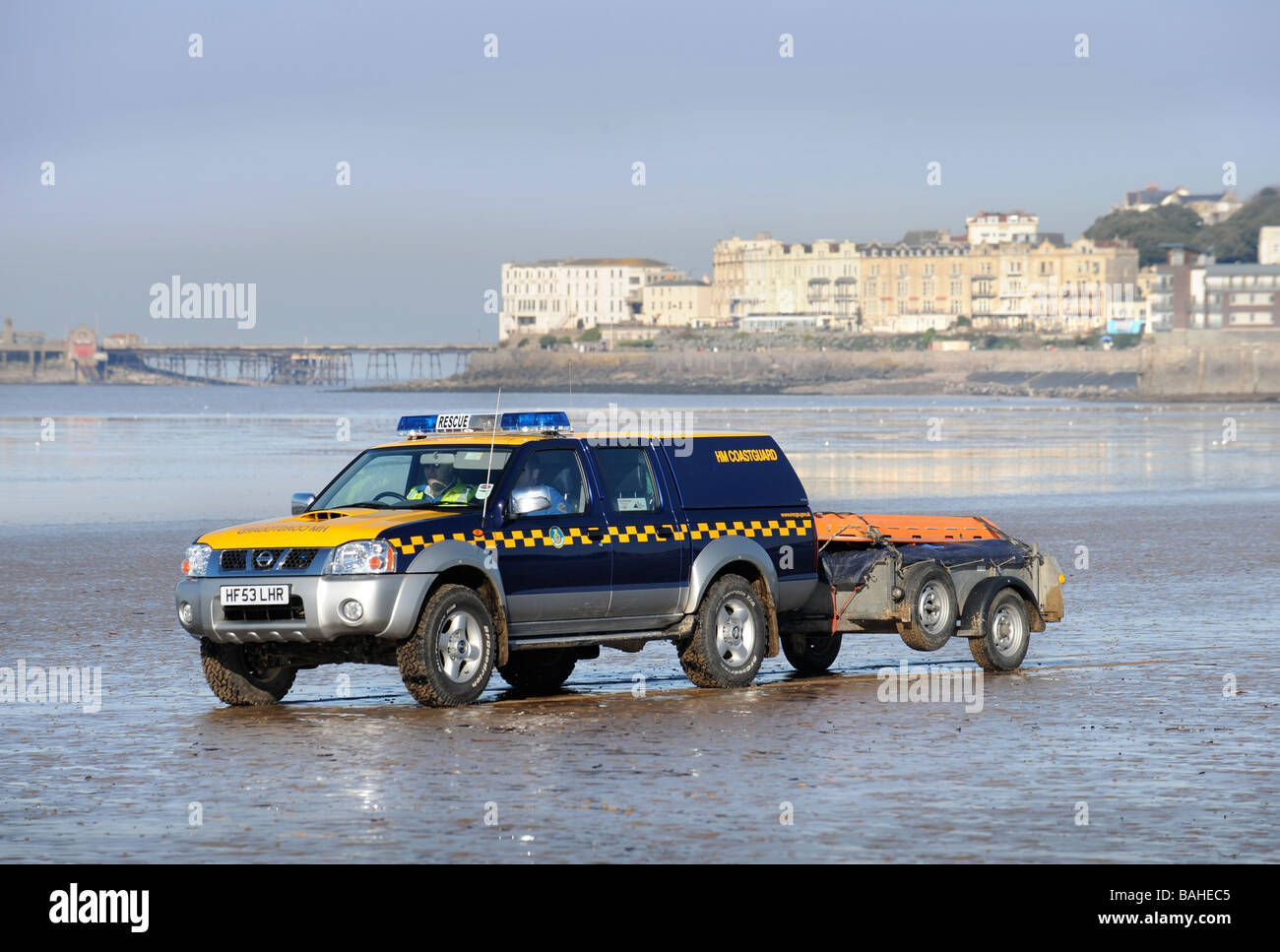 A COASTGUARD VEHICLE CROSSING THE SAND ON THE BEACH AT WESTON SUPER MARE SOMERSET UK Stock Photo
