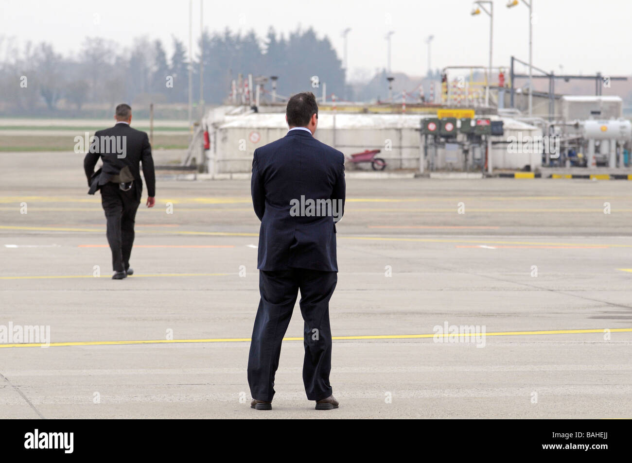 US secret service agents taking position on an airport in France ahead of the US president's 'Air Force One' plane landing. Stock Photo