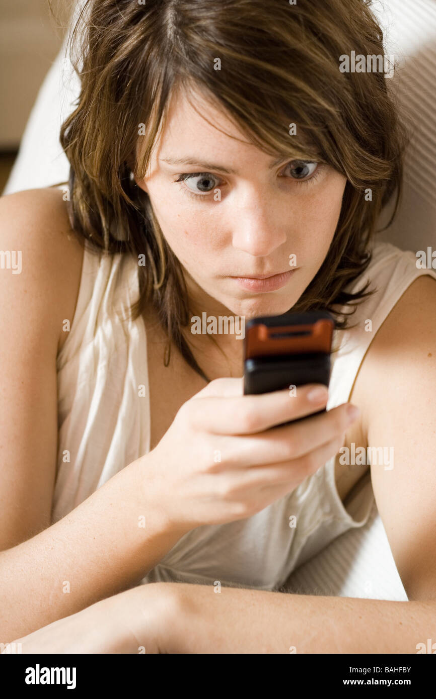 surprised woman looking at mobile phone Stock Photo