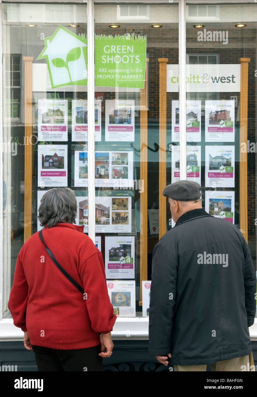 People browsing Estate Agents window display, Chichester, Sussex, UK