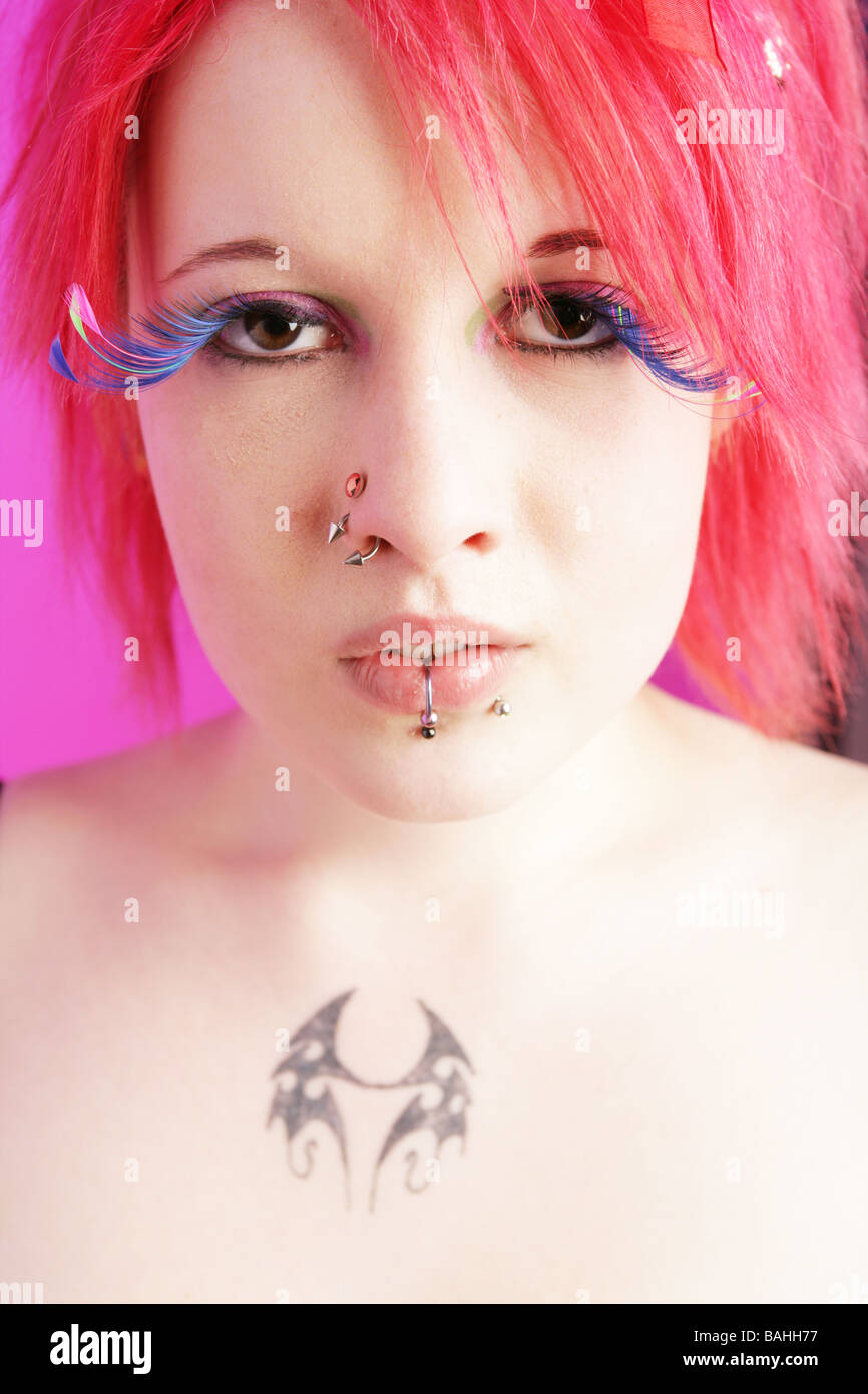 Head shot of a pretty cyber punk girl with pink hair and large fake eyelashes Stock Photo