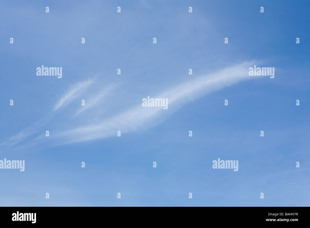 Thin wispy white Cirrus clouds in blue sky in Spring in Sussex. UK Stock Photo