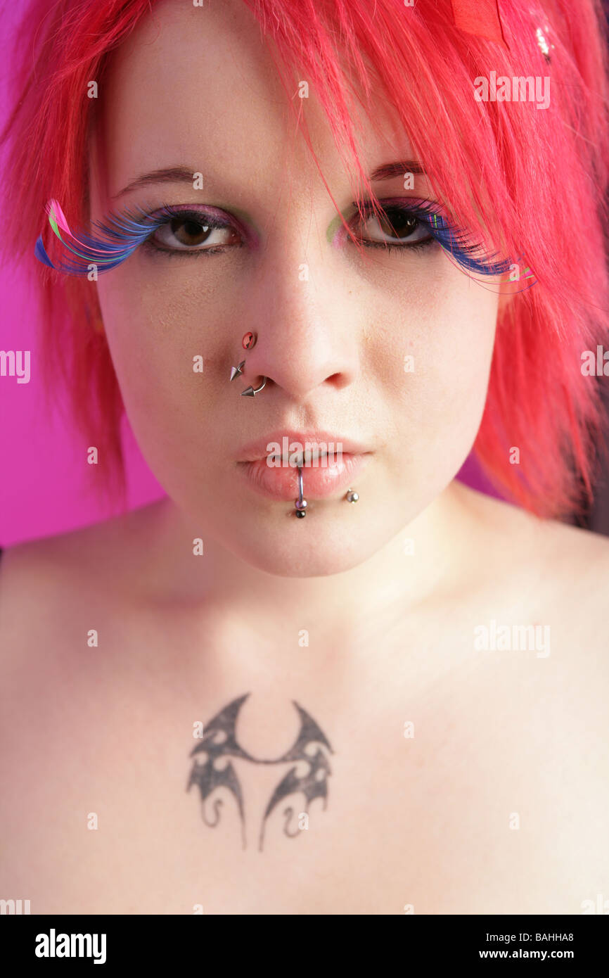 Head shot of a pretty cyber punk girl with pink hair and large fake eyelashes Stock Photo