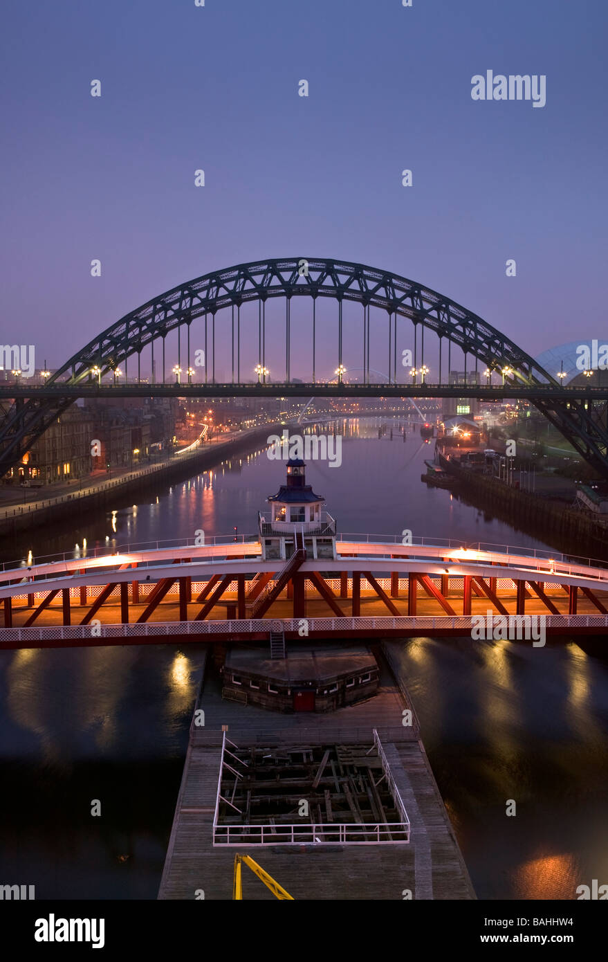 A view of the Quayside, Newcastle and Gateshead at dawn. Featuring the Tyne Bridge and the swing bridge. Stock Photo